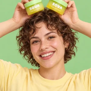 A jar of Pear Soft Balm with a pear next to it