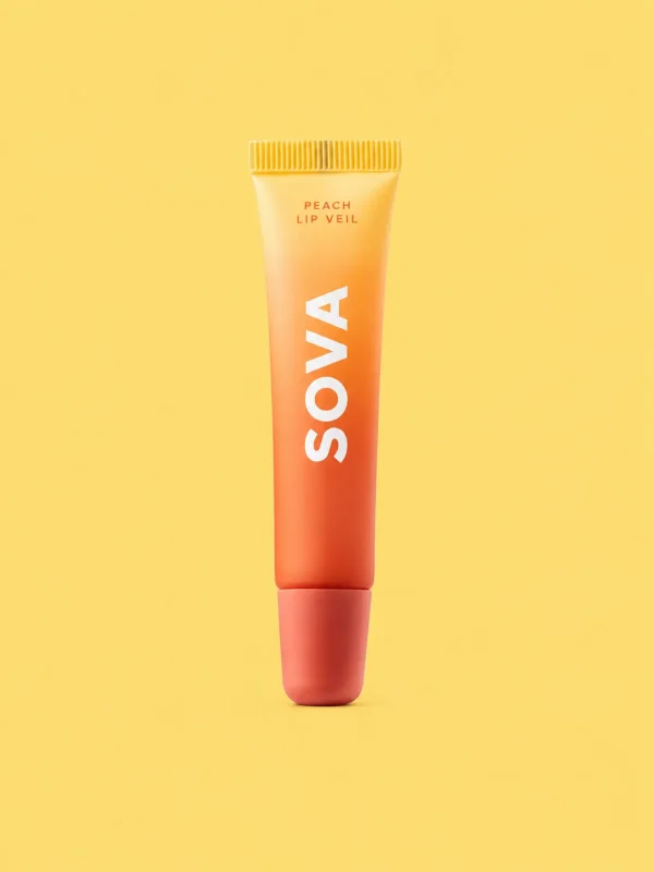 A tube of Peach Lip Veil with a peach in the background