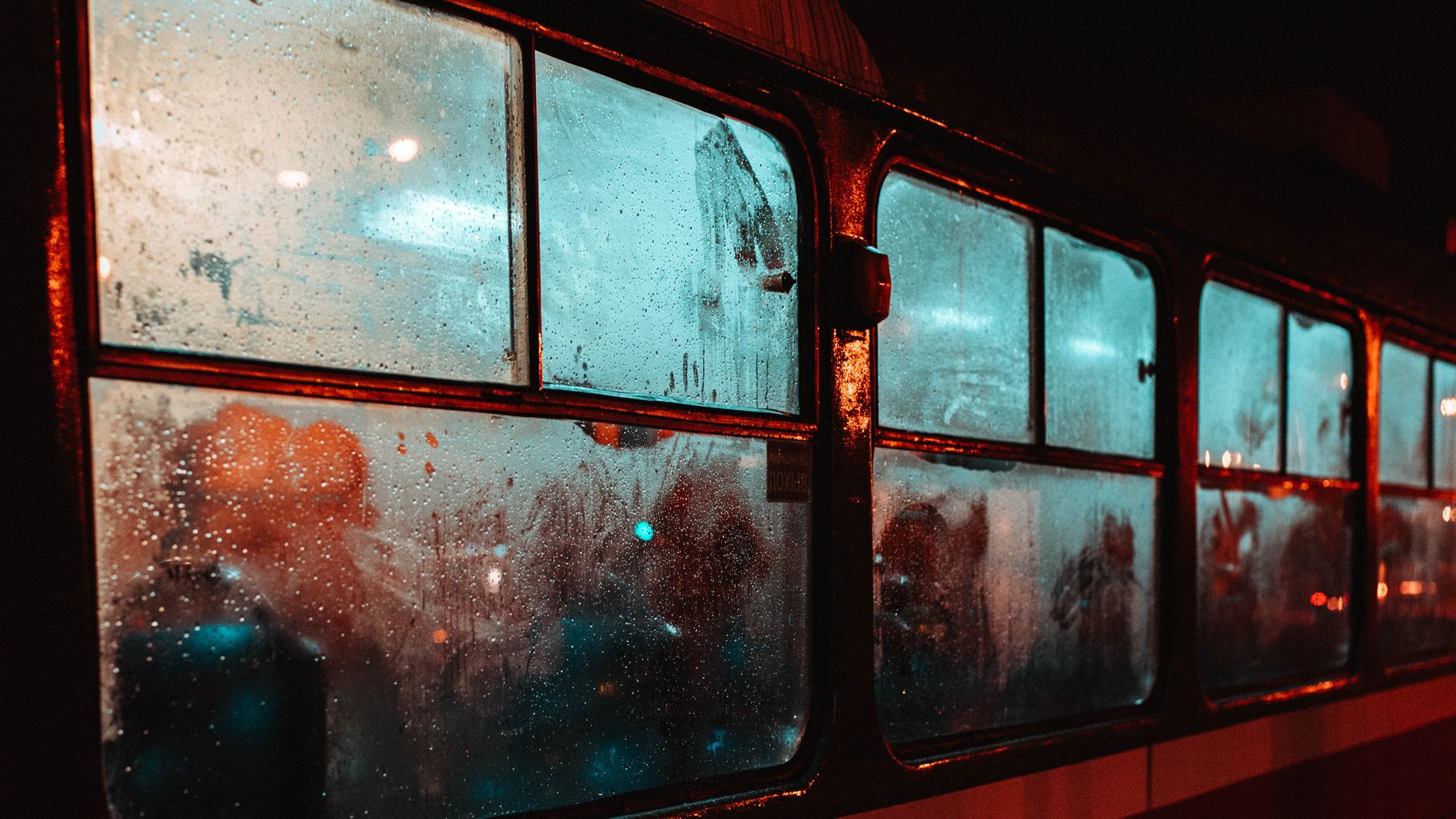 A sleeper train carriage window at dusk