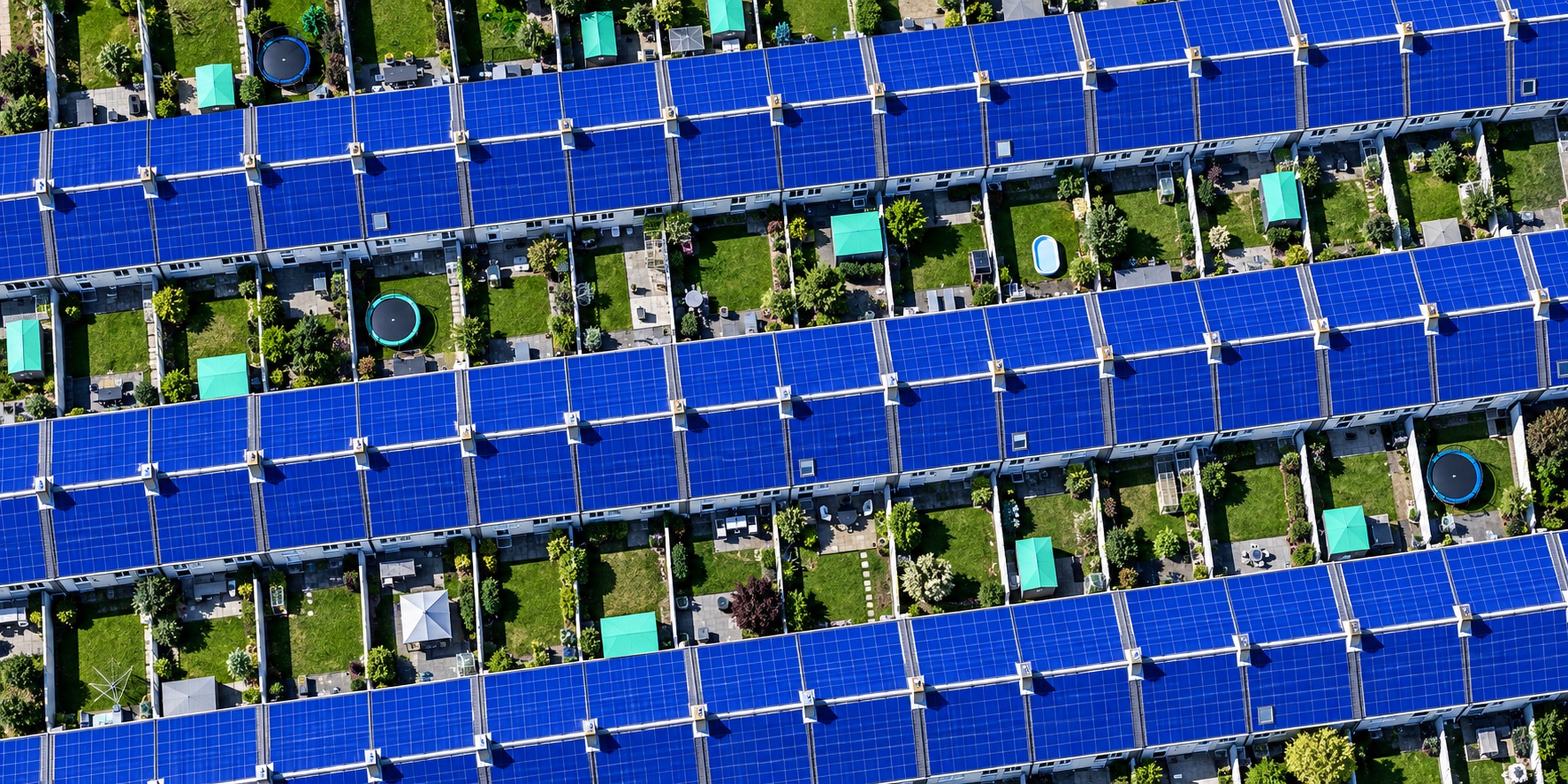 Terraced rooftops covered in solar panels, seen from above