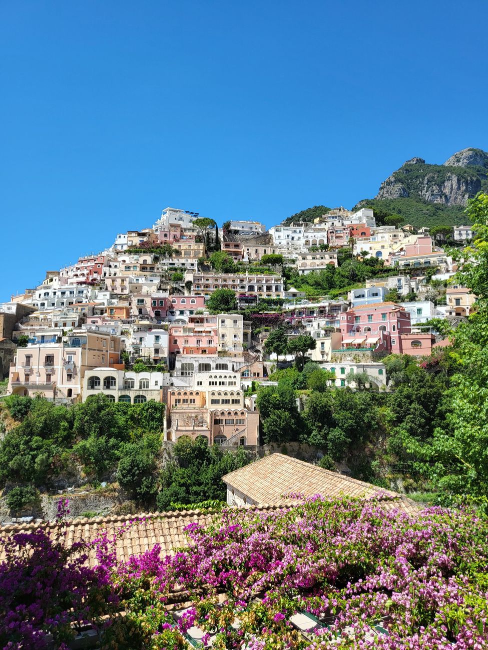 Pastel houses of Positano stacked down the cliffs to the sea