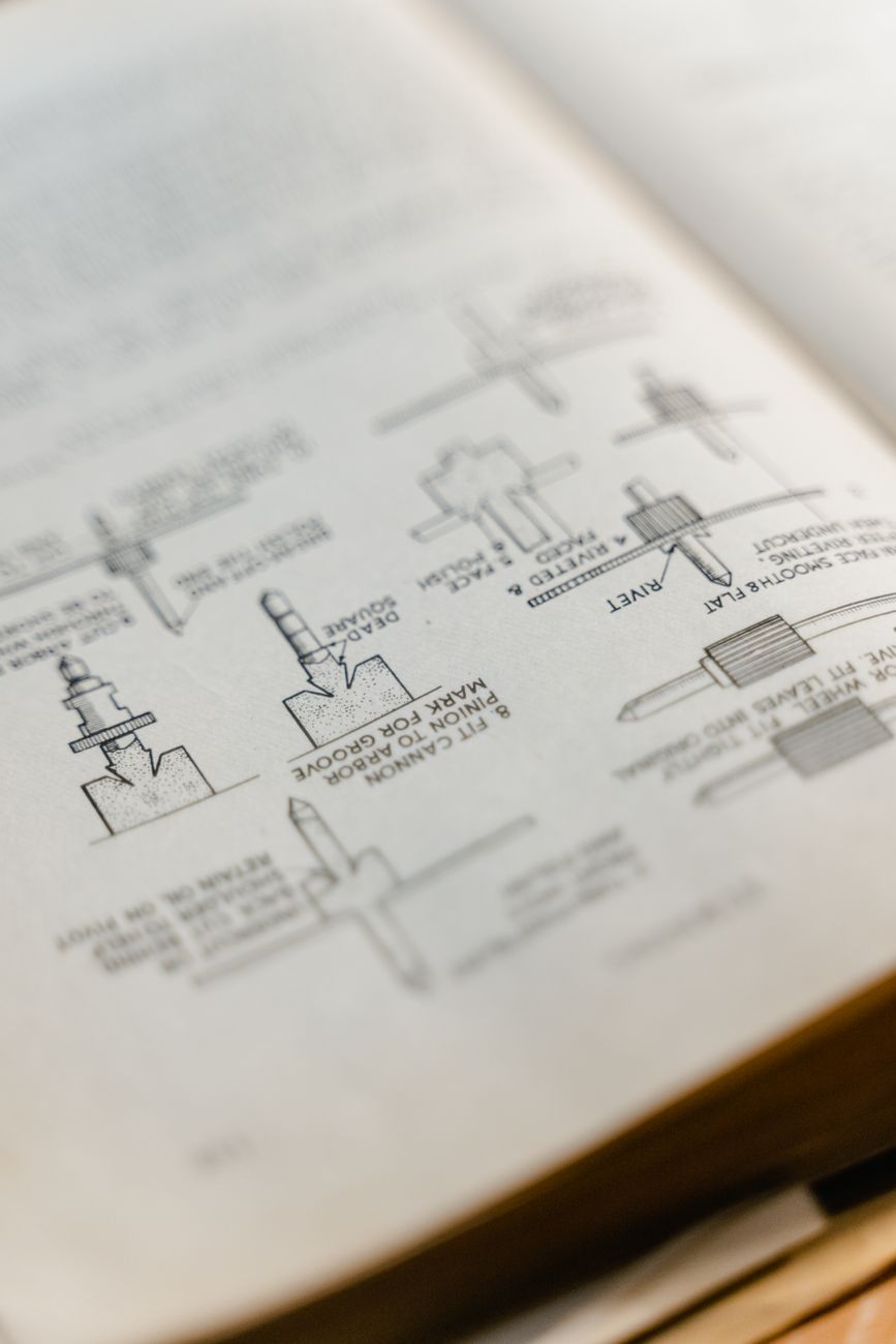 An open printed booklet with small line drawings