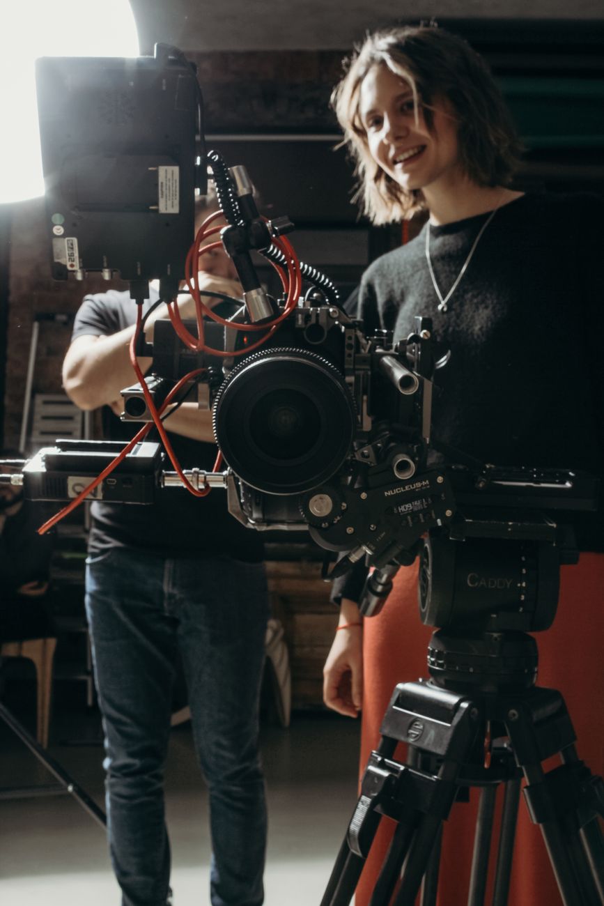 Film crew rigging a cinema camera on set