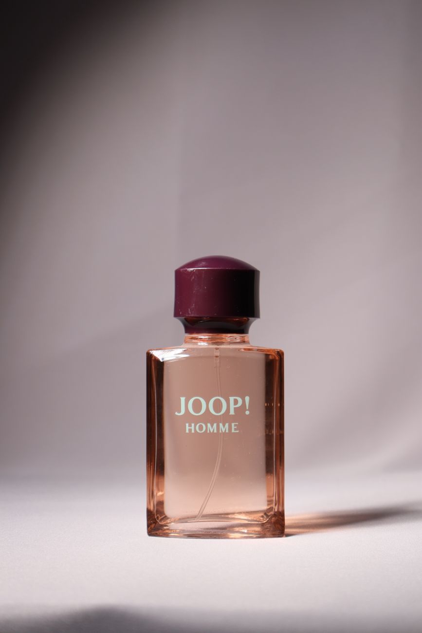 Perfume bottle lit on a tabletop set