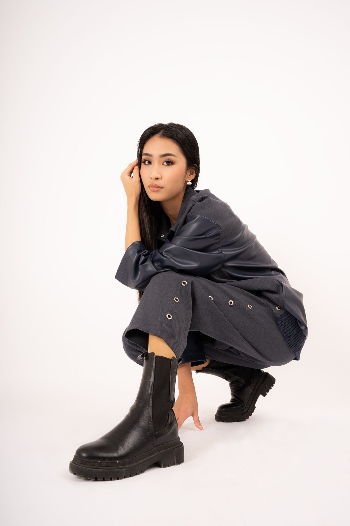 Model in black with chunky black boots