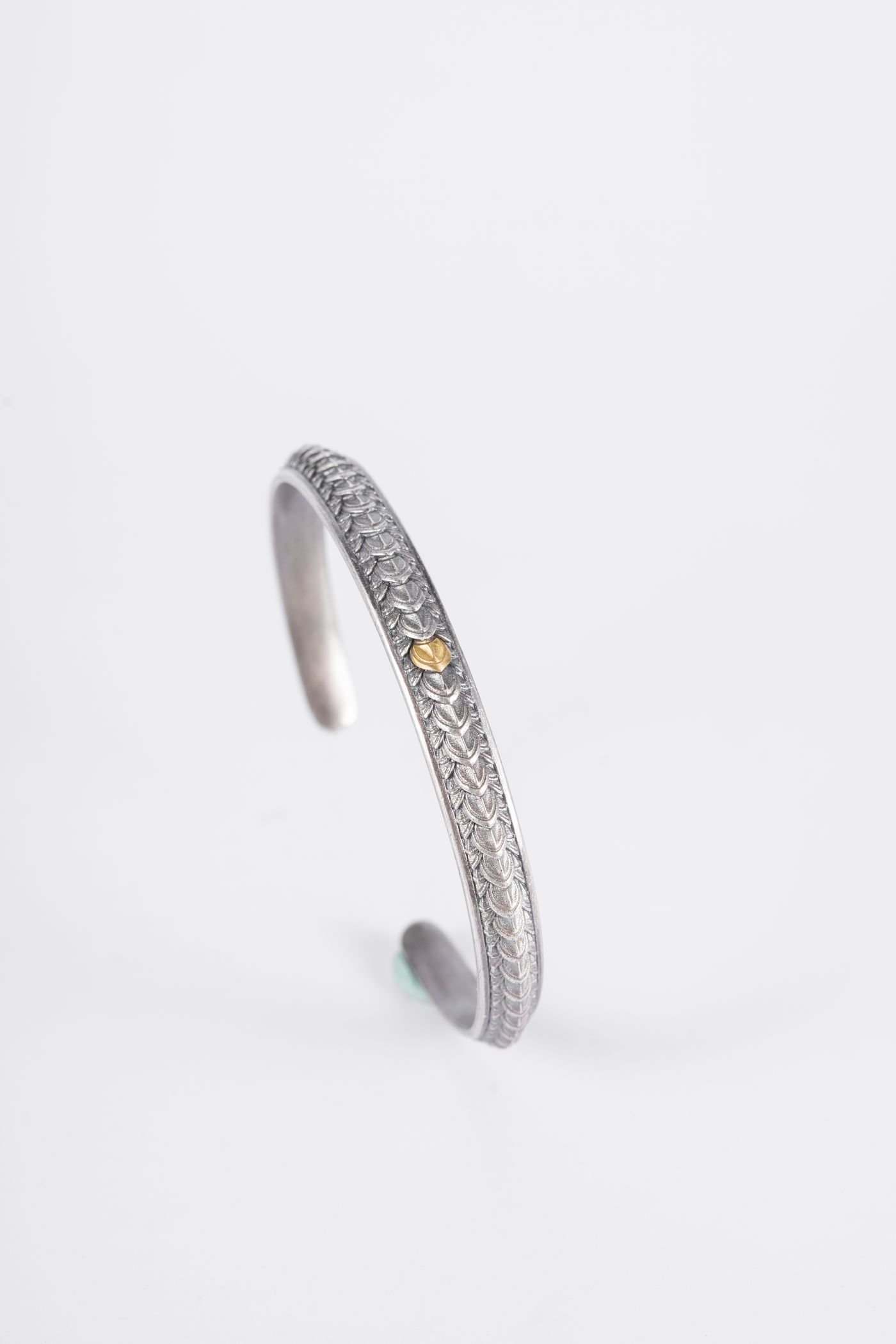 Open silver cuff bracelet on white