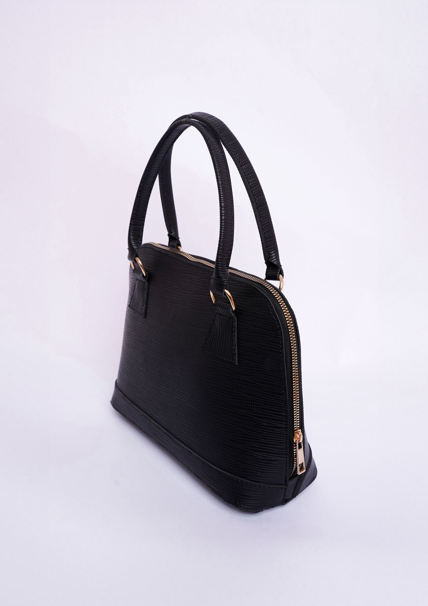 Black leather bag on a light backdrop