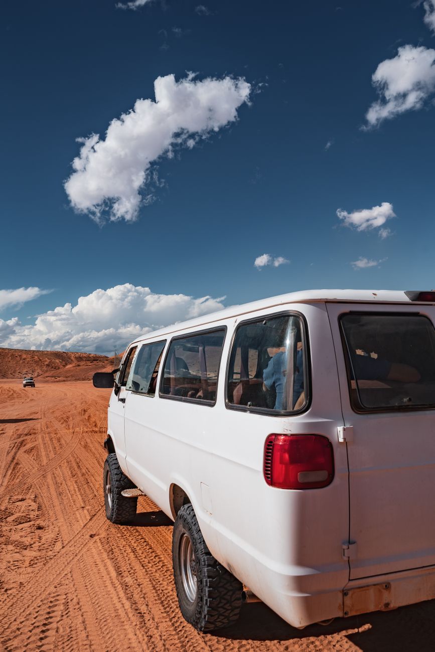 A camper van parked on an empty desert highway