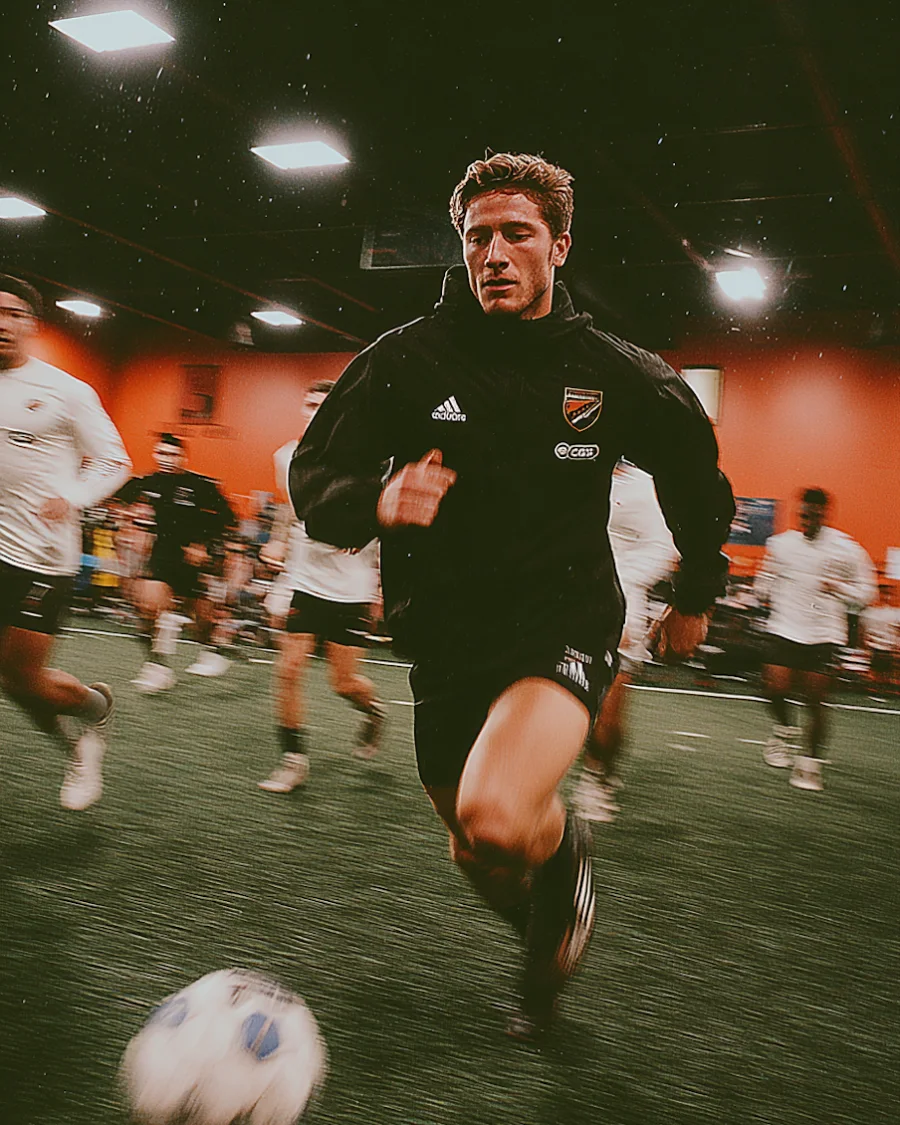 A five-a-side player breaking away under floodlights