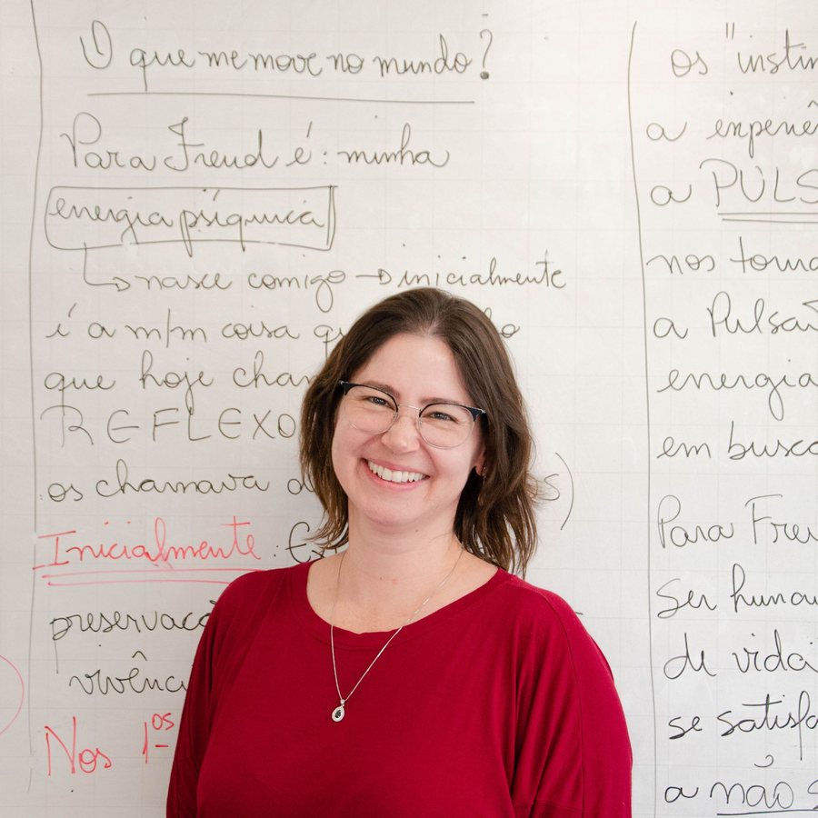 Amara Okafor, CEO of Loam, smiling in front of a whiteboard covered in handwritten notes