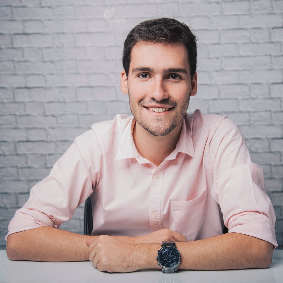 Tomás Ferreira, CTO of Gripwise, seated at a white desk in front of a painted brick wall