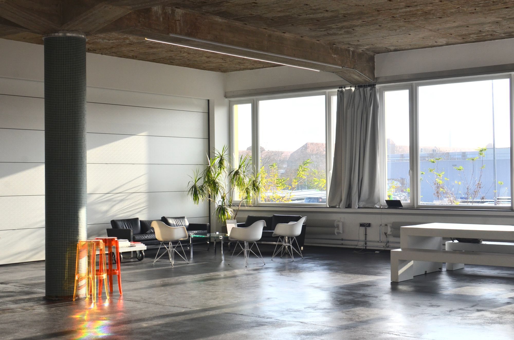 Bright loft studio with long desks and tall windows