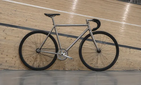 Bare steel track frame on the wooden banking of an indoor velodrome