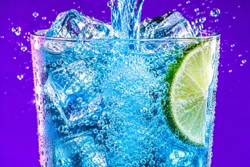 Soda pouring over ice in a glass