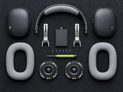 Every part of the headphones laid out on a grid with six small screws
