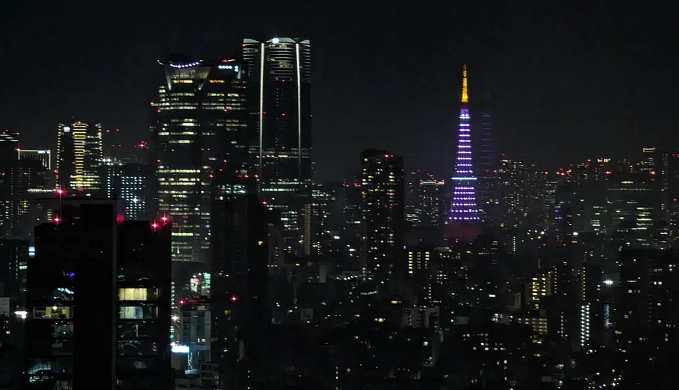Tokyo Tower lit for the cherry-blossom season above the skyline.