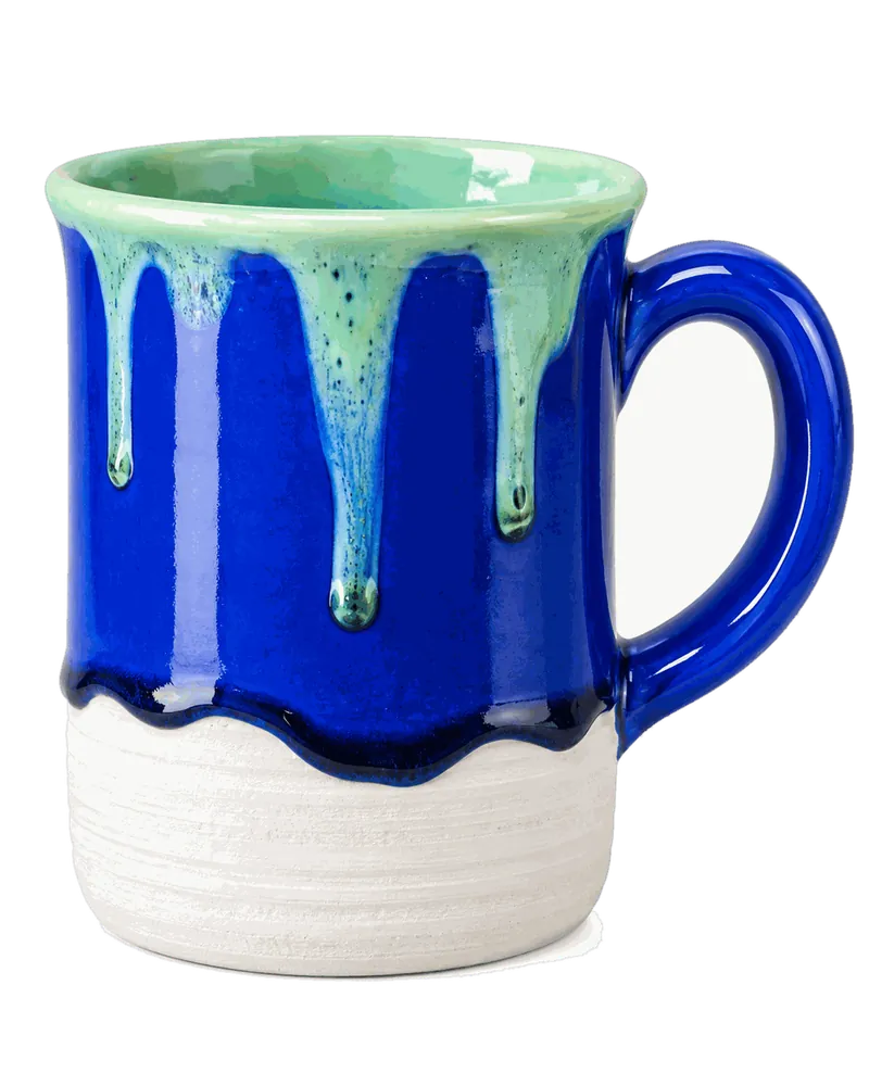 Cobalt mug with mint glaze drips from the rim
