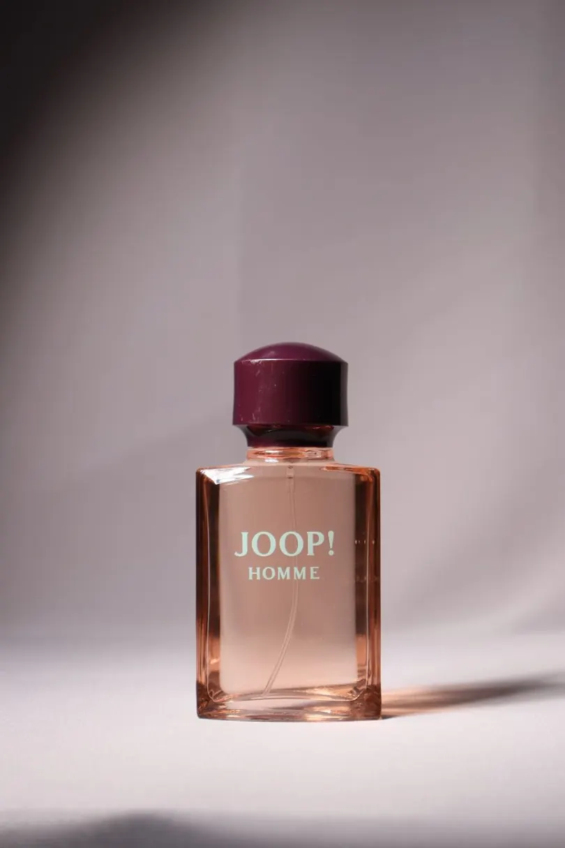 Perfume bottle lit on a tabletop set