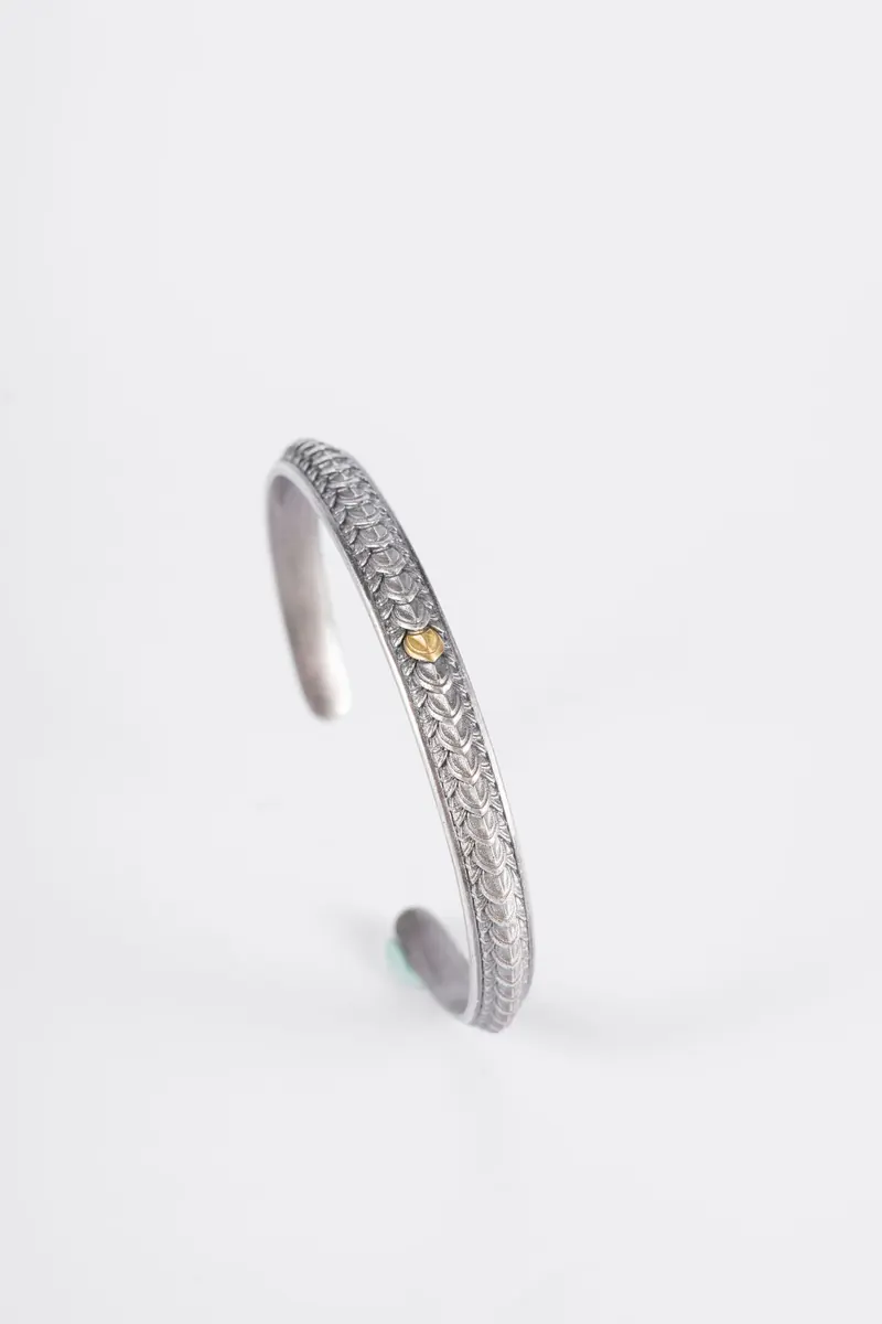 Open silver cuff bracelet on white