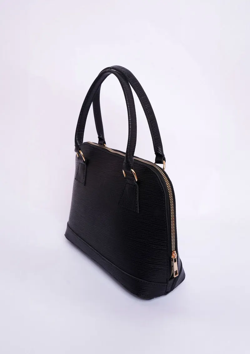 Black leather bag on a light backdrop