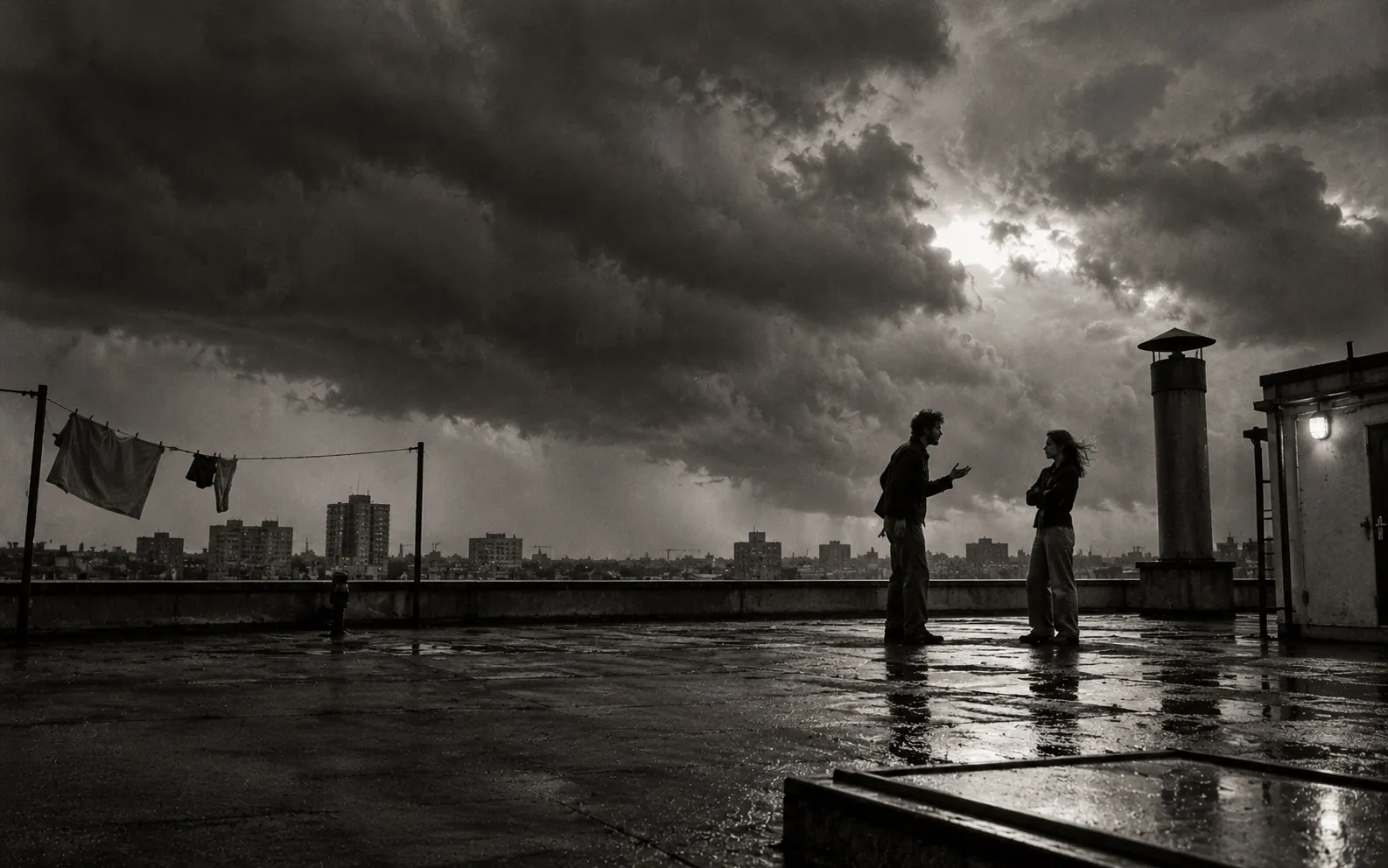 Two people on a flat roof under a building storm