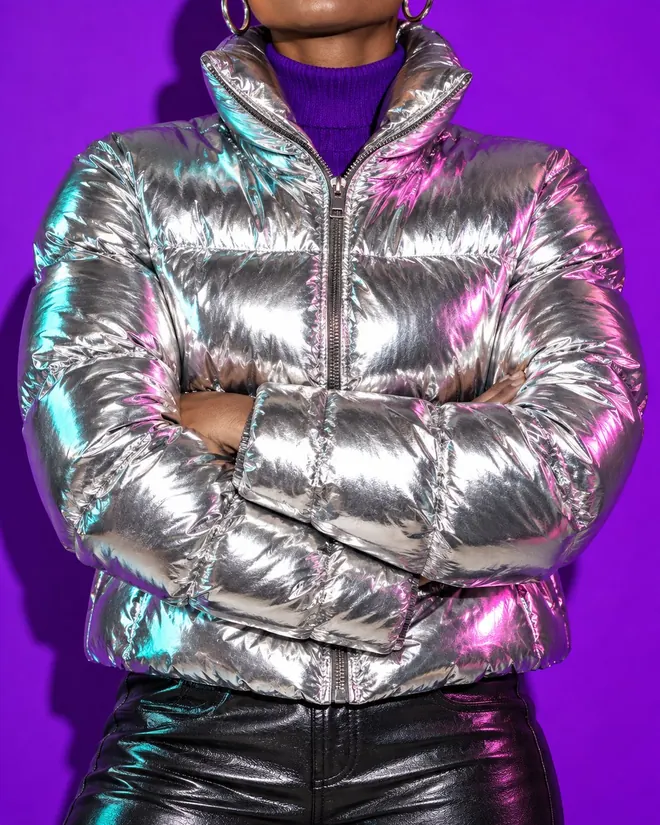 Cropped mirror-silver puffer jacket over a grape turtleneck