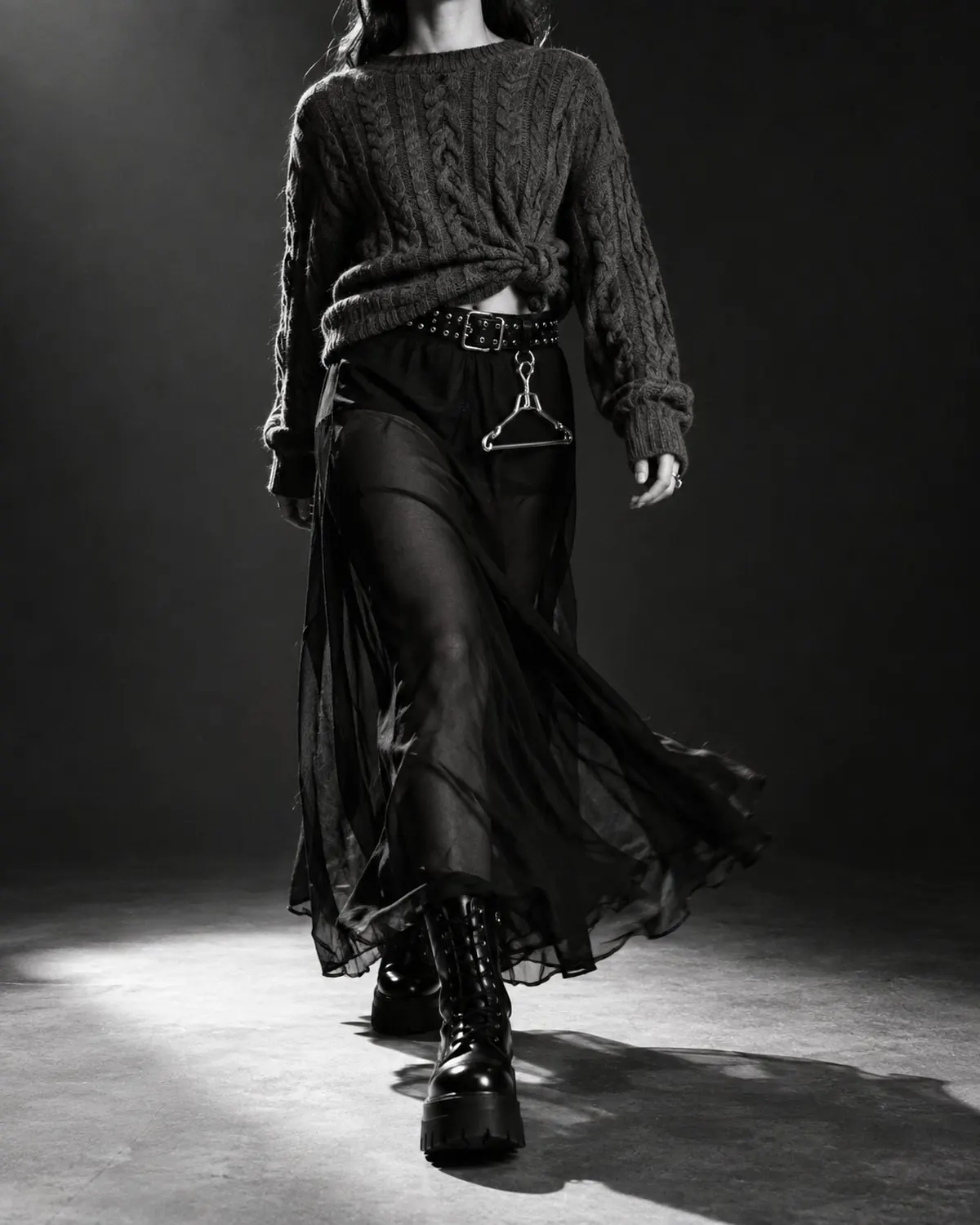 The same jumper worn back to front over a sheer black slip skirt with platform boots