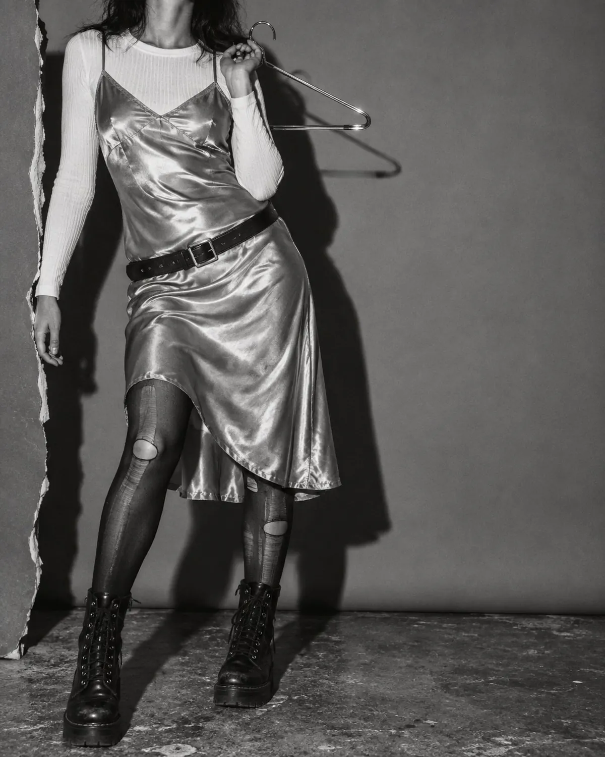 The same slip dress restyled grunge over a ribbed tee with boots and torn tights