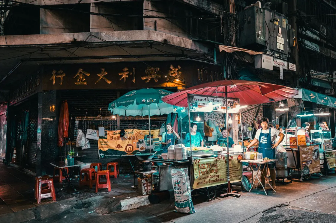 Lantern-lit food stalls at a busy night market