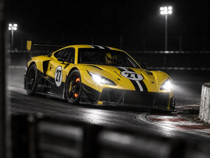 Car 27 at night with glowing brake discs entering a hairpin