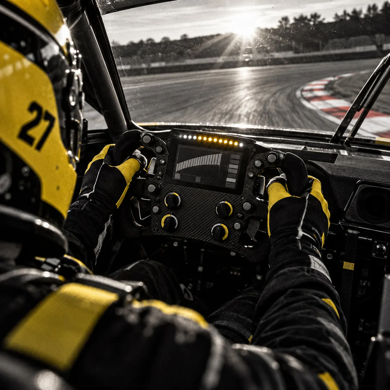 Onboard view of Luca's gloved hands on the carbon steering wheel, shift lights glowing